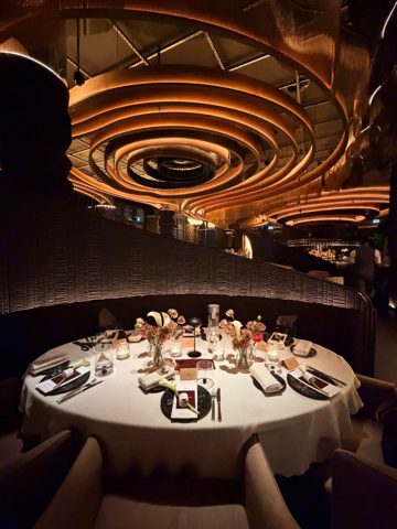 The round table at Leña under the lit ceiling